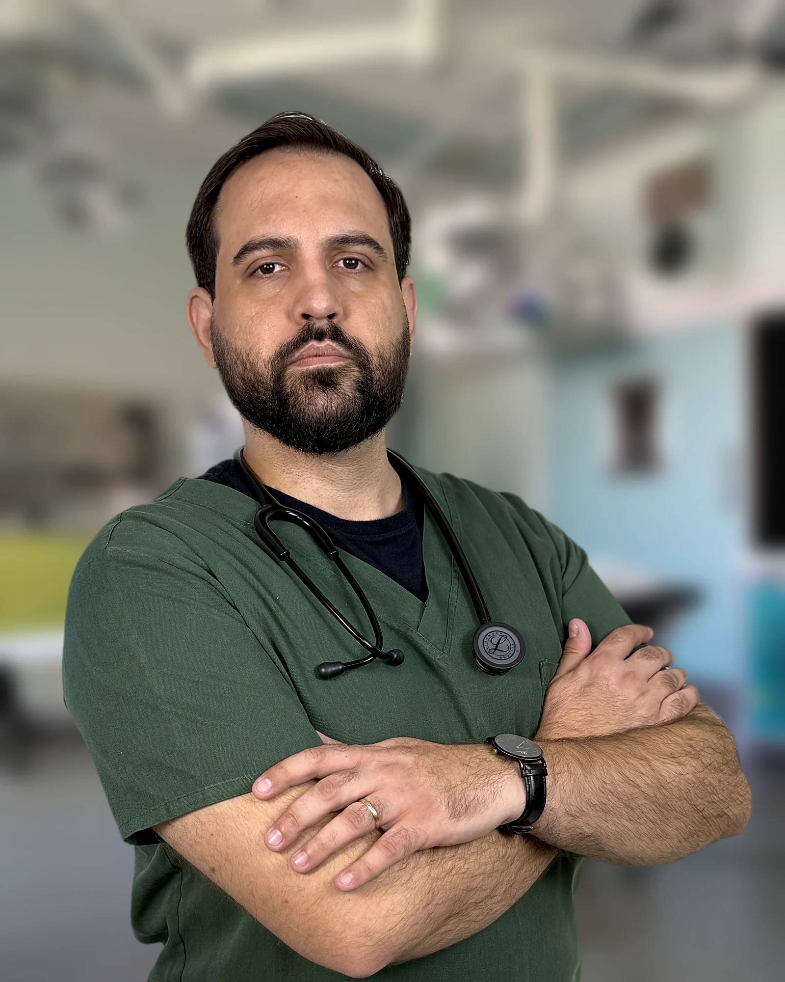 Warlen Miiller de pijama cirúrgico verde e estetoscópio, de braços cruzados